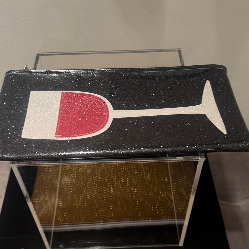 Julie Mollo, NYC, black/Rose’ wine Clutch. PVC/rubber material with glitter.